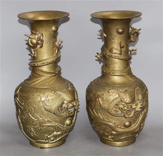 A pair of Chinese gilt bronze vases, decorated with dragons in relief, height 41cm